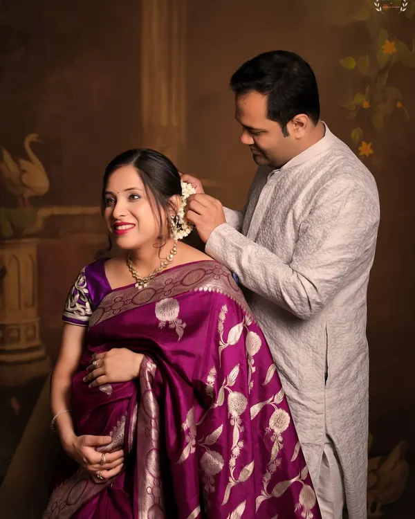 A beautiful, tender moment between a couple during their traditional maternity shoot. The husband placing flowers in her hair is a timeless gesture of love.
