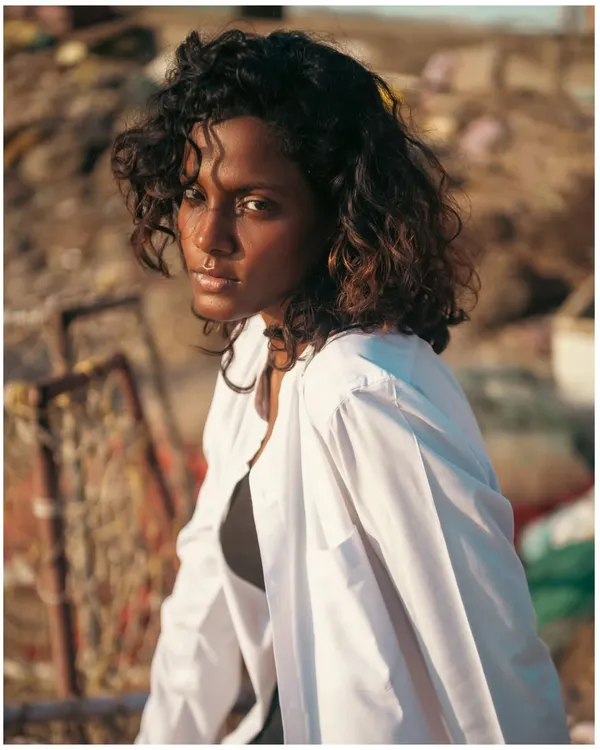Shot during the magic of golden hour at the beach. I used the warm, setting sun as my only light source to create this soft, glowing portrait. The natural light beautifully highlights the model's curly hair and creates a dreamy, authentic mood.