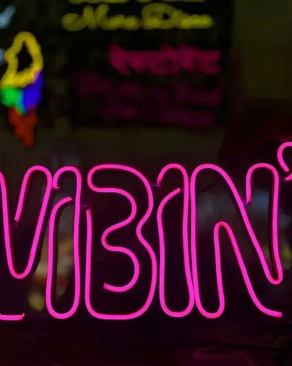 Add a cool, modern vibe to your party with a custom neon sign. This pink "VIBIN" sign is perfect for setting the mood and creating a trendy photo opportunity for your guests.