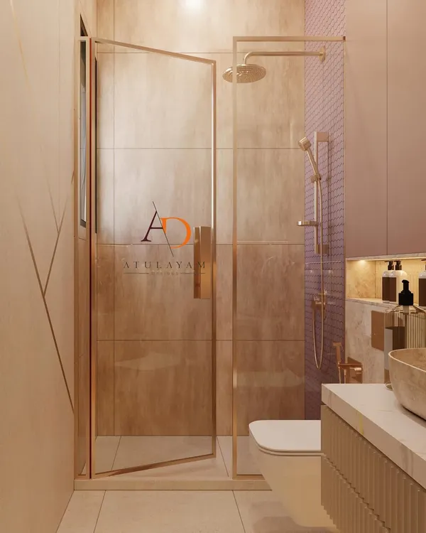 This view highlights the frameless glass shower enclosure with rose gold hardware, which keeps the bathroom feeling open and spacious.