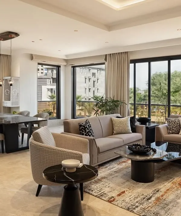 A home should feel both expansive and intimate. In this Gwalior residence, we designed the family living and dining area as one fluid space, framed by floor-to-ceiling windows that dissolve the boundary between the indoors and the serene landscape outside. The neutral palette and natural materials create a calm backdrop for life to unfold.