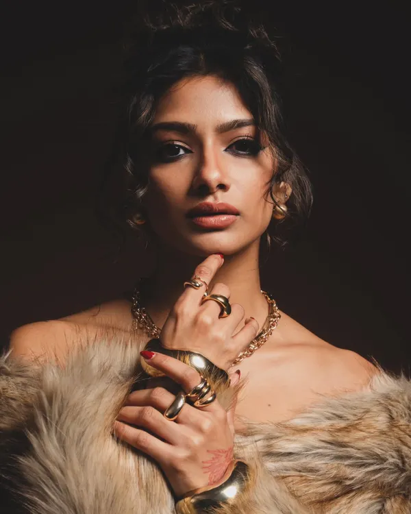 This is my signature high-fashion editorial look. I focused on creating a dramatic, smokey winged eyeliner and contoured features, complemented by bold gold jewelry and a messy high bun to achieve a powerful, sophisticated aesthetic perfect for fashion photoshoots.