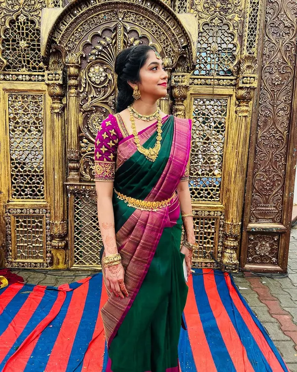 My absolute beauty, Nagambika, ready for her brother's muhurtham. For the groom's sister, we went with a natural yet radiant look, featuring glowing skin and a bright lip that perfectly matches her stunning green and purple silk saree.