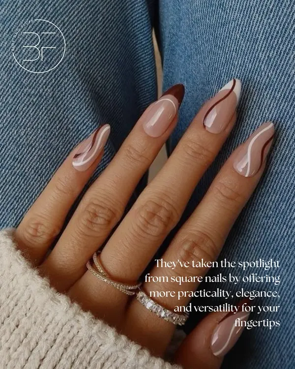 This almond-shaped set features a neutral base with elegant, free-flowing swirls in brown and white. It's a perfect example of practical, elegant, and versatile nail art.