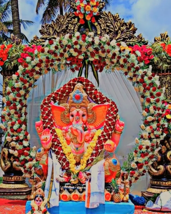 We pour our hearts into Ganesha Chaturthi celebrations. This grand idol setup features a dense, custom-made floral arch with thousands of fresh roses and chrysanthemums, creating a divine centerpiece for the festival.