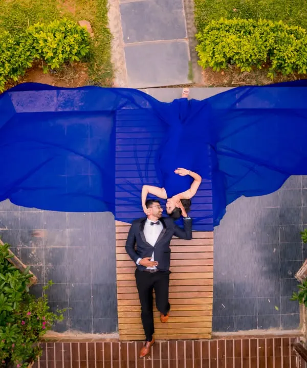 This is the kind of epic, breathtaking shot we can create together. Using a drone, I capture grand, sweeping views that turn your portrait into a piece of art, showcasing the scale of your love story against the beautiful backdrops at Elements Celebrate, Bangalore.
