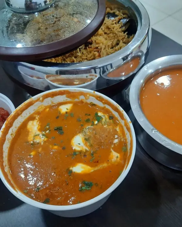 A comforting North Indian meal ready for delivery. This order included a rich paneer gravy, a flavorful biryani, and tomato soup for a small get-together.