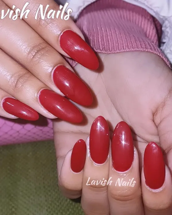 A full set of classic, glossy red nails in a sophisticated almond shape. This timeless look is bold, confident, and perfect for a bride.
