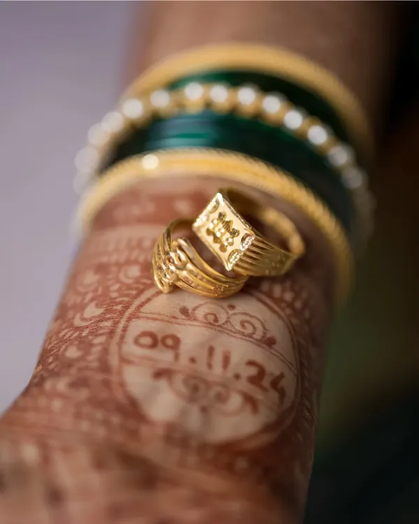 The little things tell a big story. This creative detail shot places the engagement rings over the wedding date written in henna, a unique and personal way to remember the beginning of your forever.