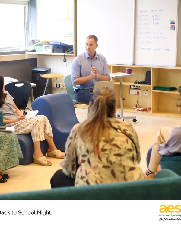 High School Back to School Night is a great chance for parents to meet teachers and learn about the curriculum. Here, a teacher leads a session in a modern, collaborative classroom space.