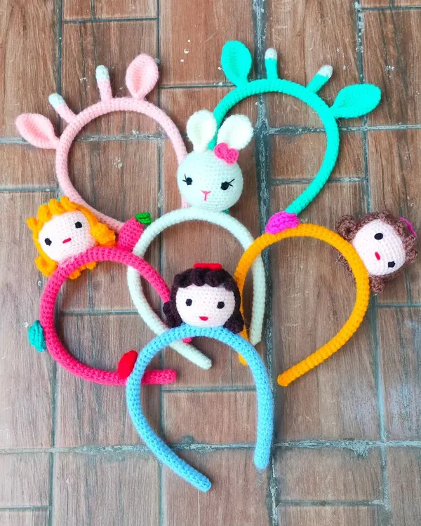 I love making these cute hair bands for little girls. This photo shows some of my favorite designs like dolls, bunnies, and monkeys. They are all made with soft cotton yarn so they are gentle and fun to wear.