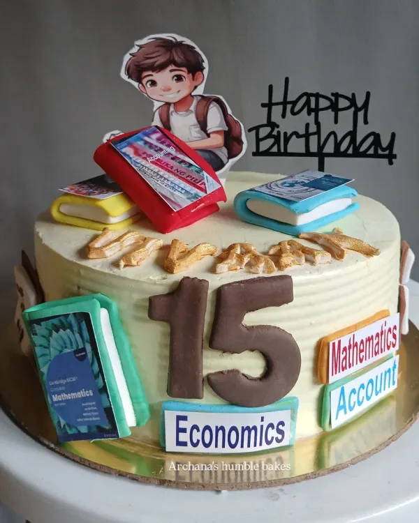 A cake for a young student celebrating their 15th birthday. It's decorated with his favorite subjects: Mathematics, Accounts, and Economics.