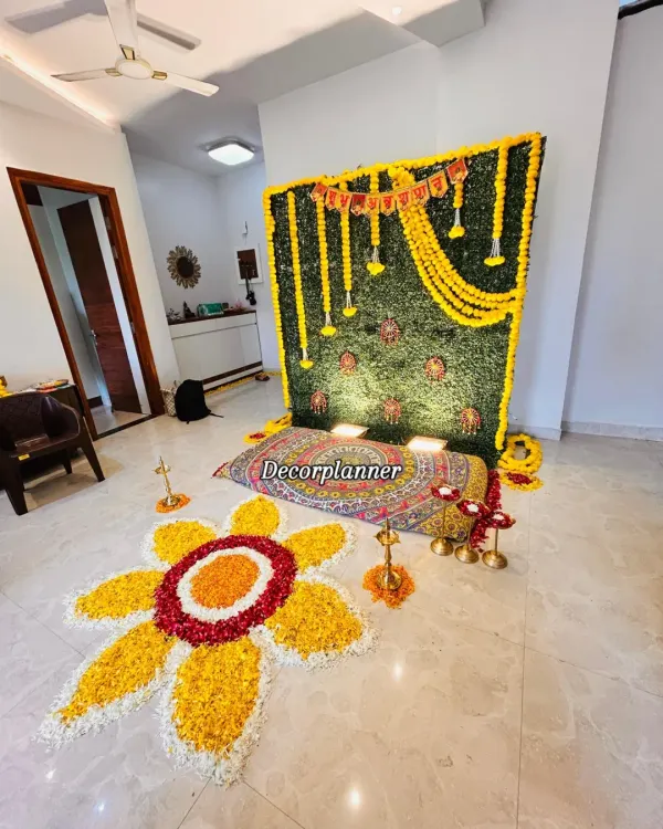 A complete view of a traditional Annaprashan ceremony setup. I used a faux grass wall panel, marigold garlands, brass diyas, and a handmade flower rangoli to create a sacred and photogenic space for the baby's first meal.