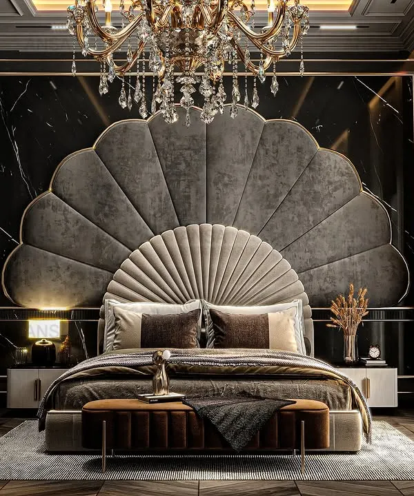This bedroom is a masterclass in dramatic elegance. The magnificent fan-shaped headboard in grey velvet creates a stunning focal point, perfectly complemented by the crystal chandelier and dark, moody wall panels. It's a space designed to make you feel like royalty.