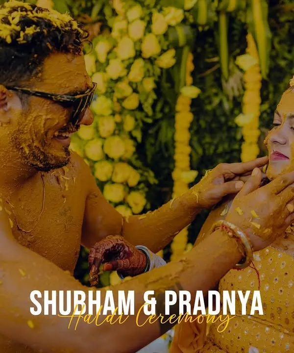 The Haldi ceremony is all about joy and color. This shot captures the couple sharing a fun, intimate moment while covered in turmeric paste.