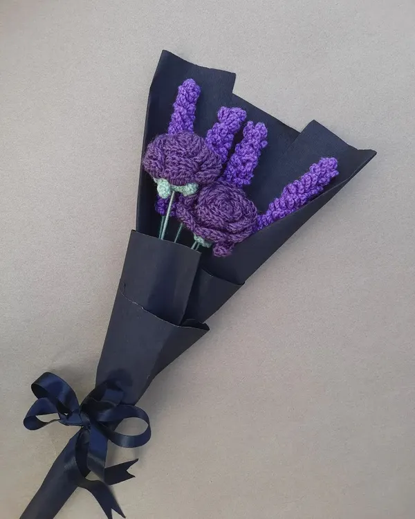 A bouquet of deep purple crochet lavender and roses, wrapped in navy paper and tied with a matching satin ribbon. This style is great for a more modern or classic look.