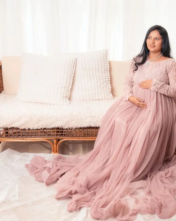 Simple, elegant, and minimal, that's our style. This mother-to-be looks absolutely radiant in a flowing pink gown, creating a soft and dreamy maternity portrait.