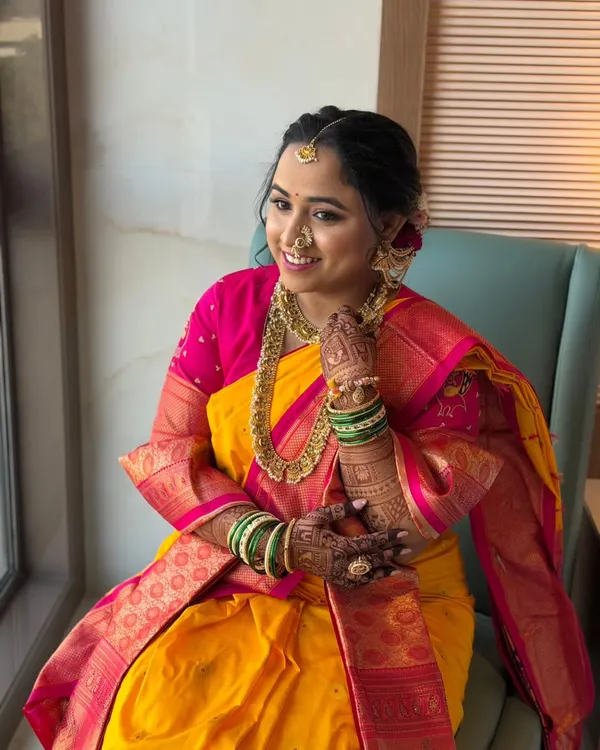 A portrait of a radiant Maharashtrian bride. Her makeup is intentionally gentle and filter-free, designed to feel light on the skin while enhancing her natural grace. The focus is on a subtle glow that looks beautiful in natural light.