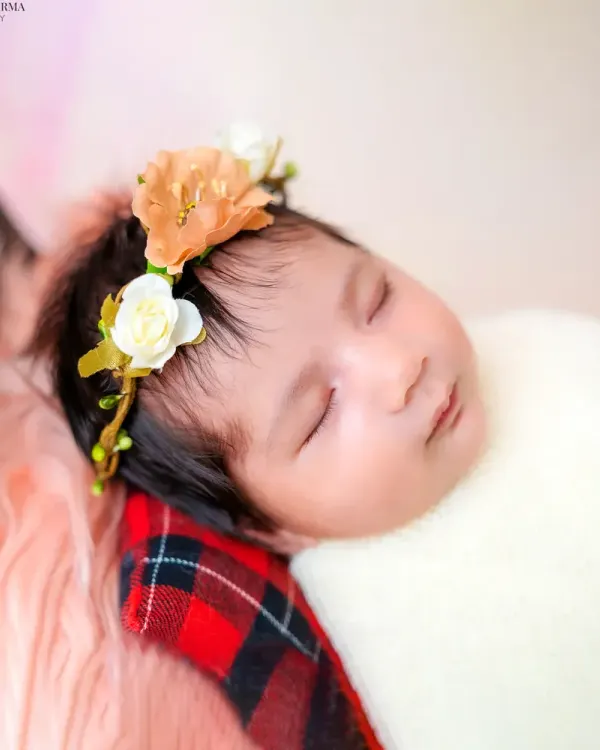 A close-up of a sleeping newborn with a delicate floral headband. I focus on capturing these peaceful, angelic moments that pass by so quickly.