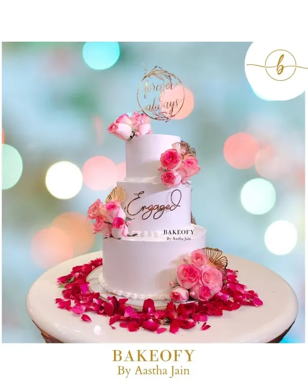 This three-tier fresh fruit cake was for a beautiful engagement ceremony. The design is clean and elegant, with fresh pink roses and delicate pearl details, all surrounded by a bed of rose petals. It felt surreal to be part of such a special day.