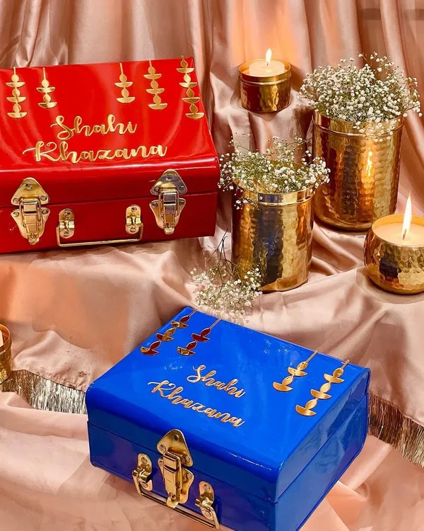 My "Shahi Khazana" or royal treasure trunks are designed for the most special festive gifting. Available in vibrant red and royal blue, they are adorned with golden diyas to capture the essence of Diwali.