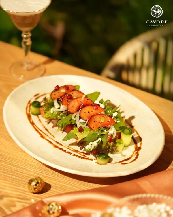 A refreshing start to the evening. This salad features fresh strawberries, crisp greens, and pomegranate seeds, all brought together with a light dressing and balsamic glaze for a balance of sweet and tart notes.