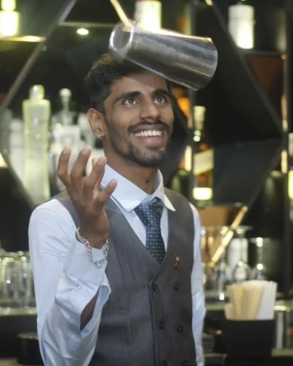 It's not just about the drink, it's about the show. One of our flair bartenders balances a shaker with a smile, adding a dynamic and entertaining element to the guest experience.