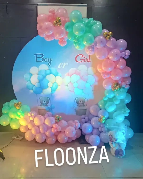 This "Boy or Girl" gender reveal backdrop is a popular choice. I use a mix of pink, blue, green, and purple balloons to create a whimsical feel, complete with cute teddy bear details and hot air balloon graphics on the main circular panel.