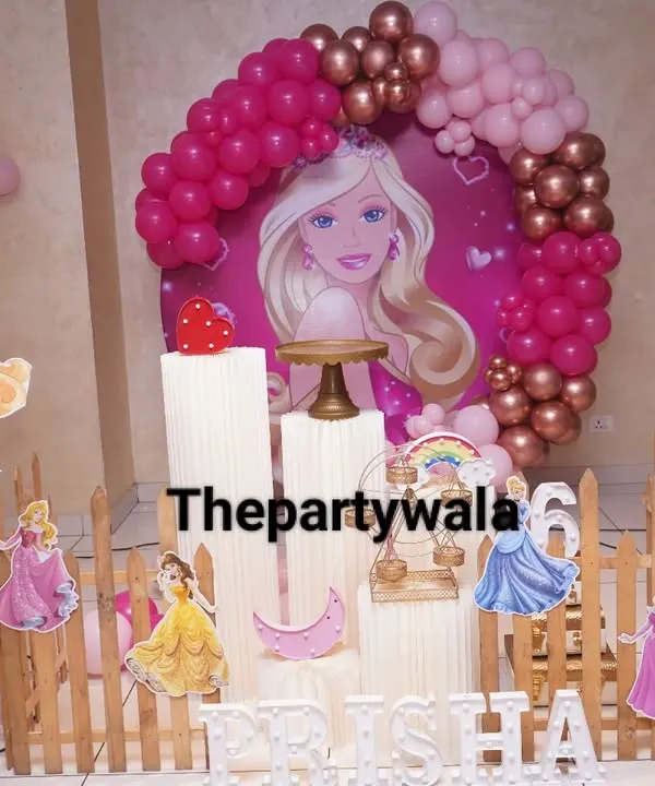 A classic Barbie theme, perfect for a glamorous birthday. This setup includes a large Barbie backdrop, character cutouts, and a pink and rose gold balloon arch.
