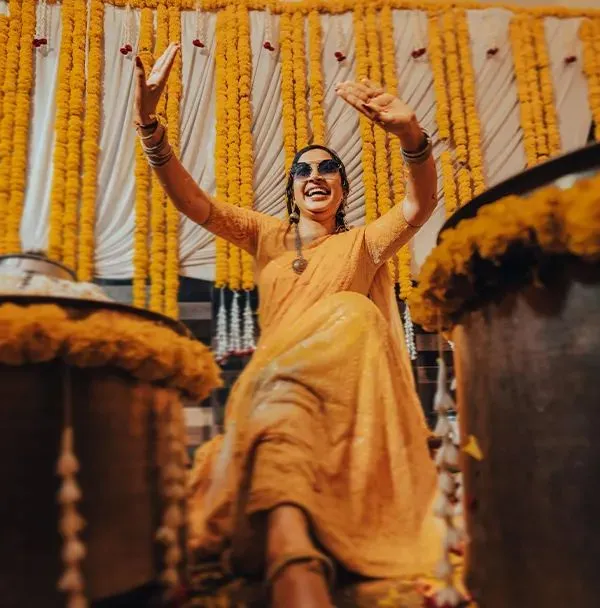 The bride, full of energy and joy, dances during her Haldi ceremony. We capture the celebration in its most candid and lively form.