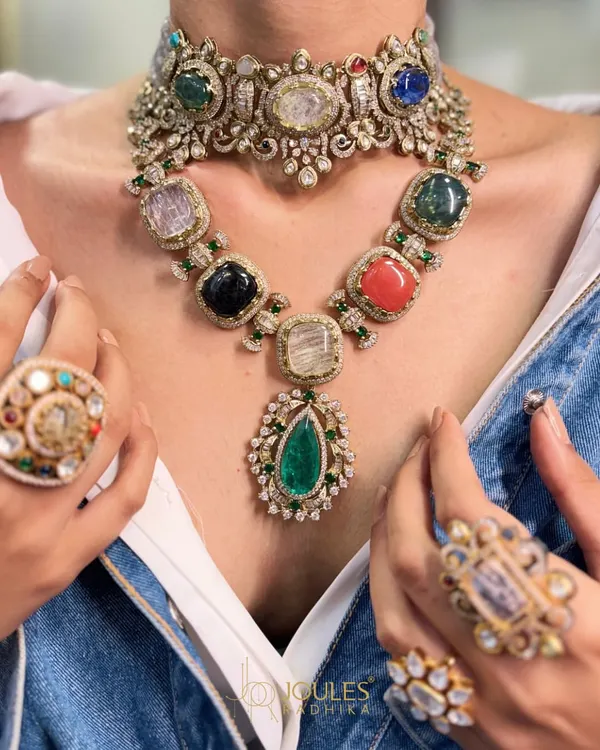 More is more when it comes to creating a moment. This look features a Navratna-style choker layered with a matching gemstone necklace, surrounded by statement rings, for a truly maximalist and royal statement.