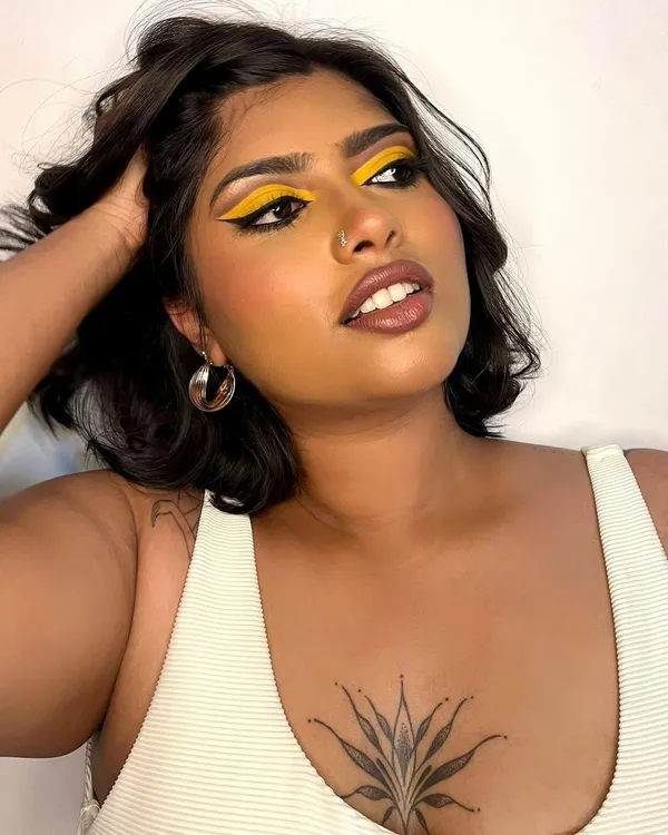 A bold and graphic look featuring a vibrant yellow eyeshadow. This kind of creative makeup is perfect for editorial shoots where you want to make a statement with color.