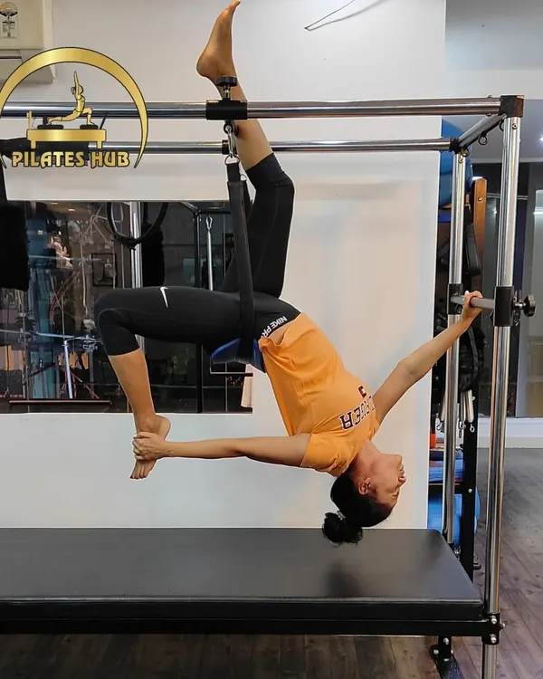 A demonstration of an advanced single-leg inversion on the Cadillac. This move requires immense core control, flexibility, and trust in your body.