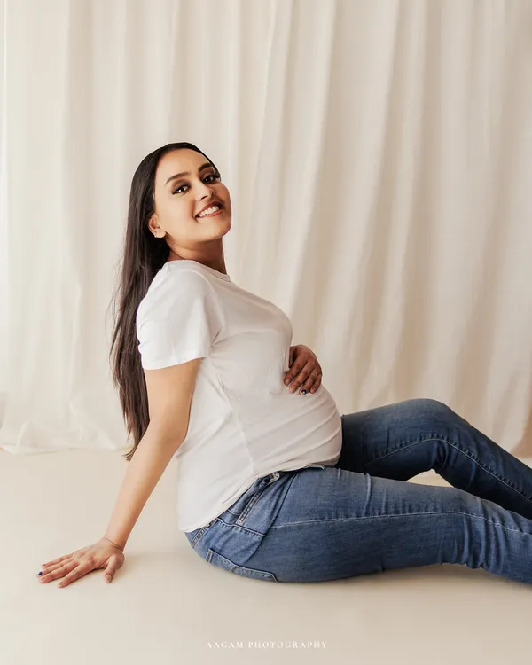 Just you, your bump, and a happy smile. This casual portrait in a simple white tee and jeans is all about celebrating your authentic self during this special time.