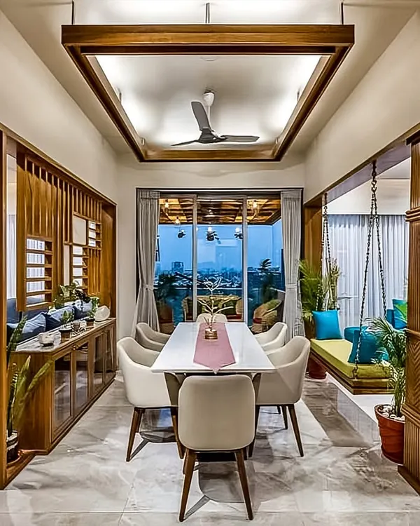 This open-plan living and dining area captures my approach to creating cohesive, inviting spaces. I used warm wood tones, a traditional Indian swing (jhoola), and modern furniture to design a space that is perfect for both family dinners and relaxation.