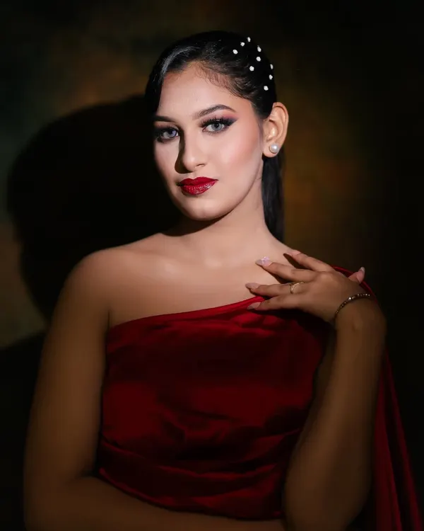 A classic glamour look featuring a bold red lip and dramatic winged eyeliner. The lighting creates a beautiful shadow, highlighting the model's features. This is a timeless look every artist must master.
