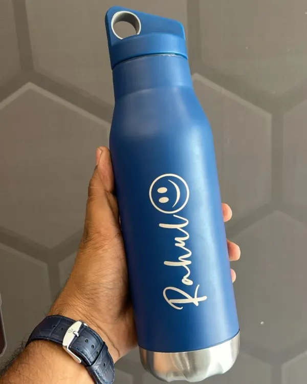 A stylish blue stainless steel bottle personalized with the name "Rahul" and a smiley face. This is a great example of a simple, fun, and practical personalized gift.