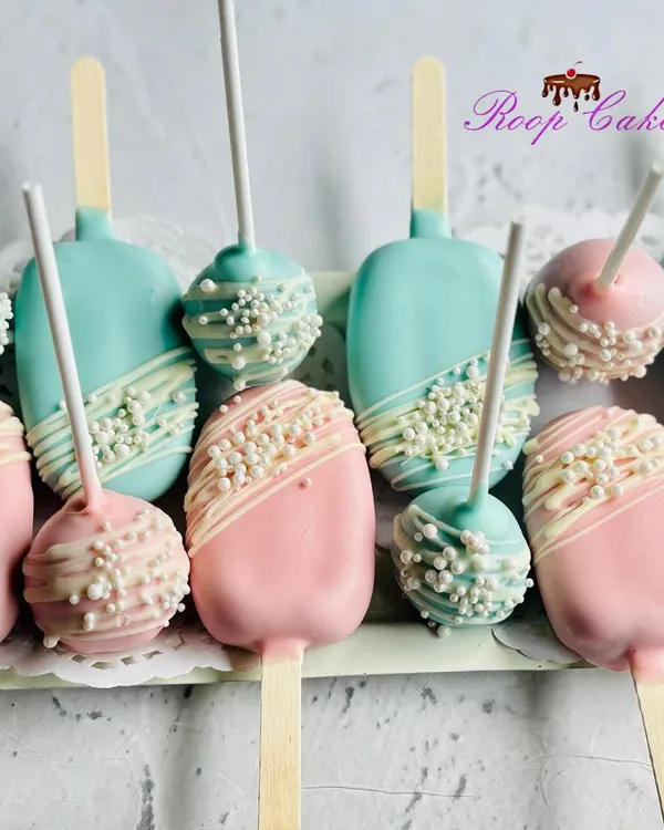 A popular choice for modern baby showers, these cakesicles and cake pops add a stylish touch to any dessert table. The combination of pink and blue keeps the mystery alive for a gender reveal.