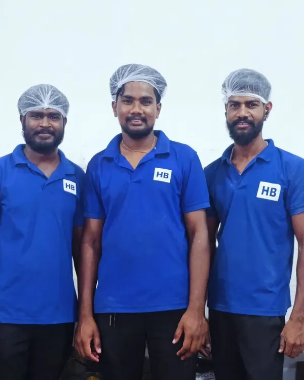 Our dedicated team members in their smart blue HB uniforms and hairnets, representing our commitment to professionalism and hygiene.