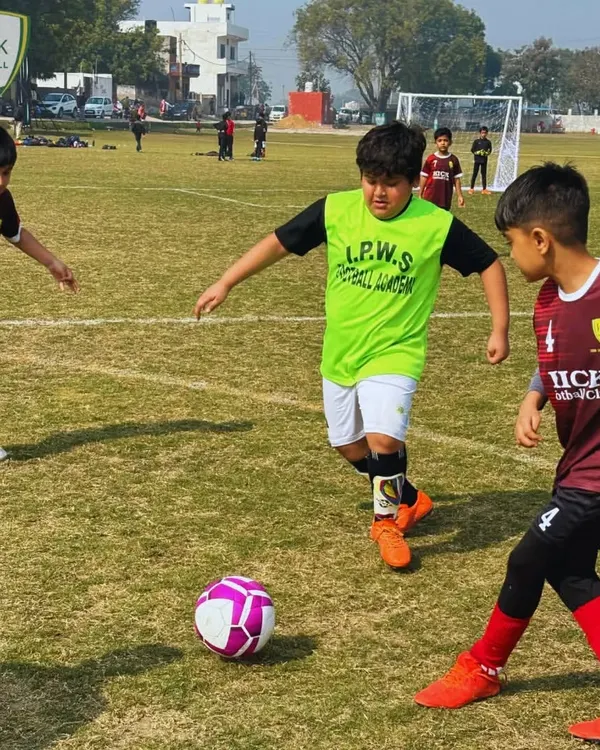 Two players challenge for the ball in a competitive match. This moment captures the intensity and teamwork that defines football.