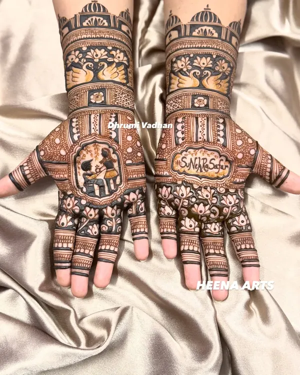 This is what I call telling a story. For this engagement bride, we included a beautiful portrait of the couple, their initials, and traditional motifs like swans and palace architecture to create a design that's uniquely theirs. This is full hand bridal mehendi at its most personal.