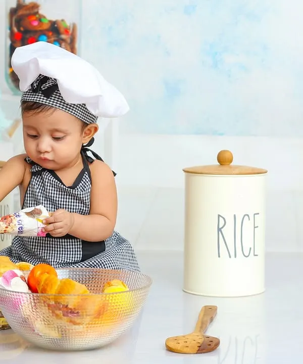 This little chef is carefully inspecting the ingredients. My chef-themed shoots are filled with fun props for your culinary artist to explore.