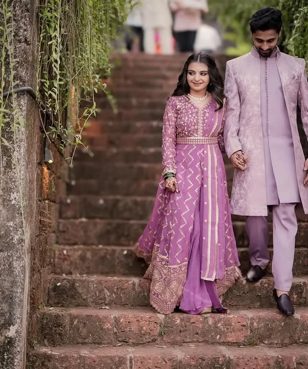 A grand, fairytale entrance. This couple looks regal in their matching lavender traditional outfits during their engagement shoot.