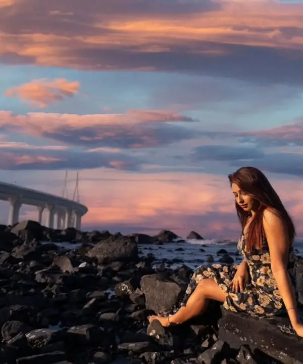 Dreaming in the city of dreams. A beautiful portrait set against the rocky Mumbai shoreline with the Bandra-Worli Sea Link and a pastel sunset sky.