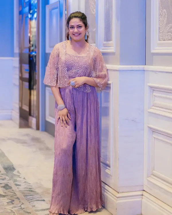 I styled singer Priyanka Barve in this chic pastel lavender jumpsuit with a matching embellished cape for an event in Pune. It's a modern, sophisticated, and comfortable alternative to traditional wear.