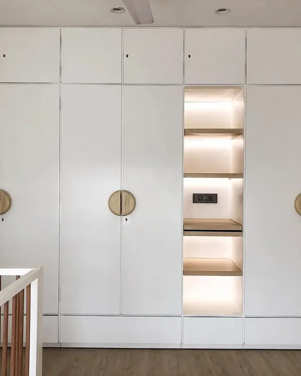 This large, modern wardrobe provides incredible storage for a growing child. I designed it in a clean white finish with a beautifully lit central niche for displaying special toys or books. The round wooden handles are easy for little hands to use.