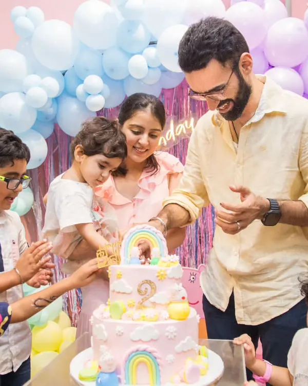 The cake cutting ceremony is a special moment for the whole family. Look at all those happy faces!