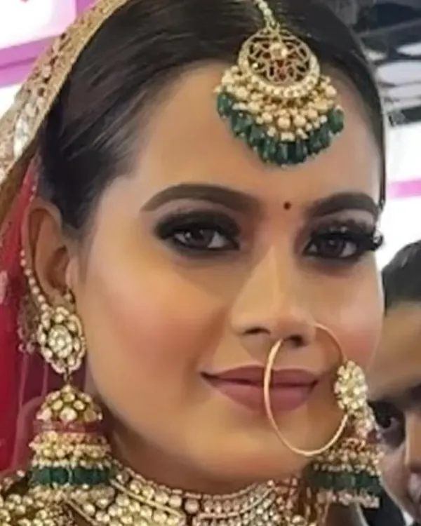 A close-up of a flawless bridal look. I focus on HD makeup that is perfect for photography, ensuring the skin looks radiant and smooth, with sharp, defined eyes and lips that complete the traditional bridal aesthetic.