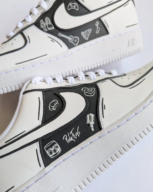A close-up of a monochrome doodle AF1, telling the story of a client who is a singer, gamer, and foodie. Every icon represents a piece of their life.