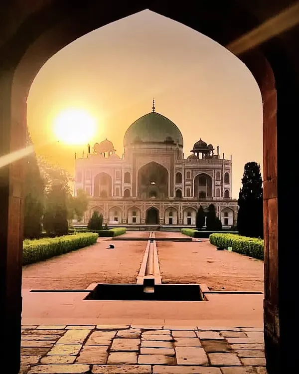 A view of Humayun's Tomb at sunset, framed perfectly by a stone archway. This is the kind of breathtaking moment I love to share on my walks, where light, architecture, and history converge to create something truly magical. This tomb, a 16th-century Mughal masterpiece, set the precedent for the Taj Mahal.